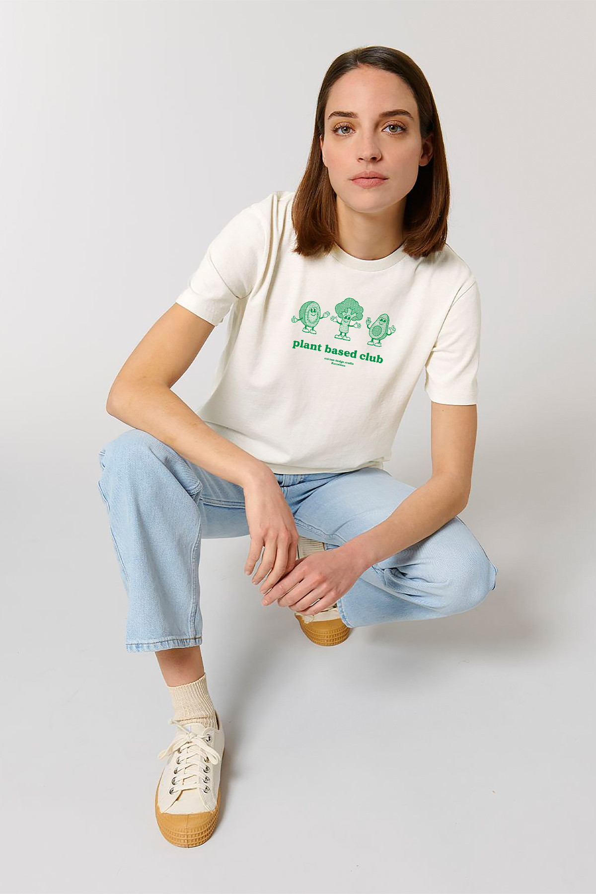 Model wearing a white tshirt with a vegetables print
