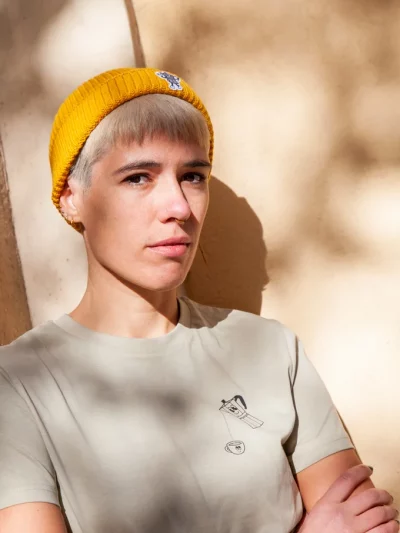 Model with a yellow beanie with a coffee maker illustration embroided
